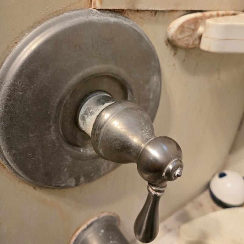 Price Pfister shower valve handle with corrosion detail