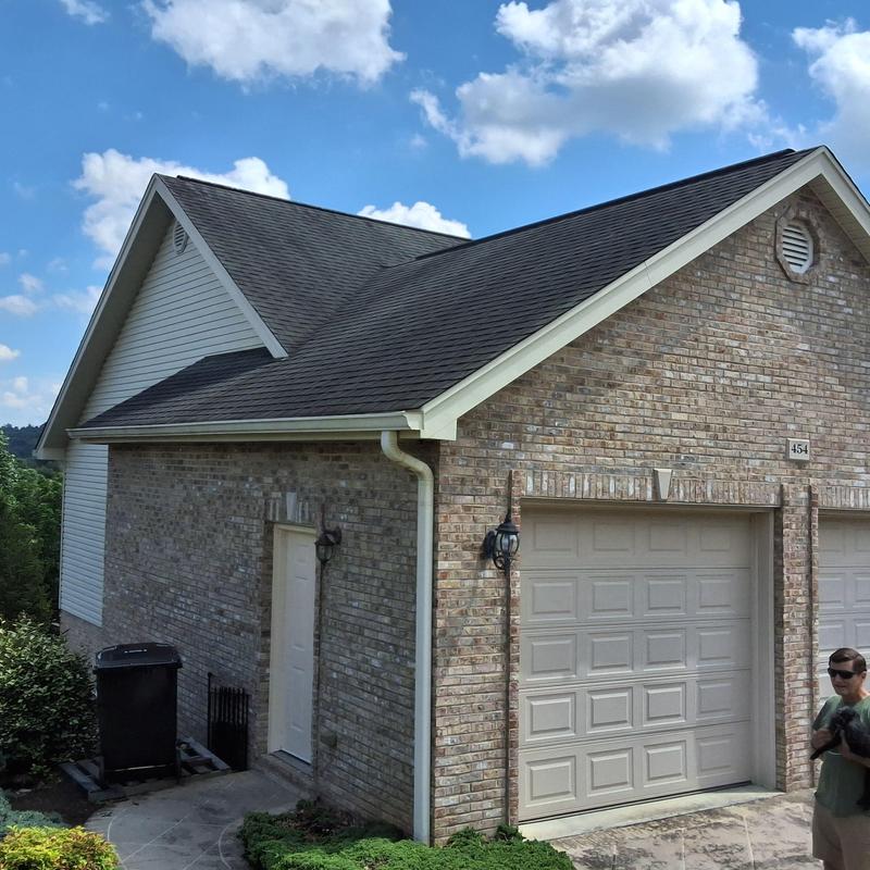 Asphalt shingle roof and gutters on residential home Asphalt shingle roof and gutters on residential home