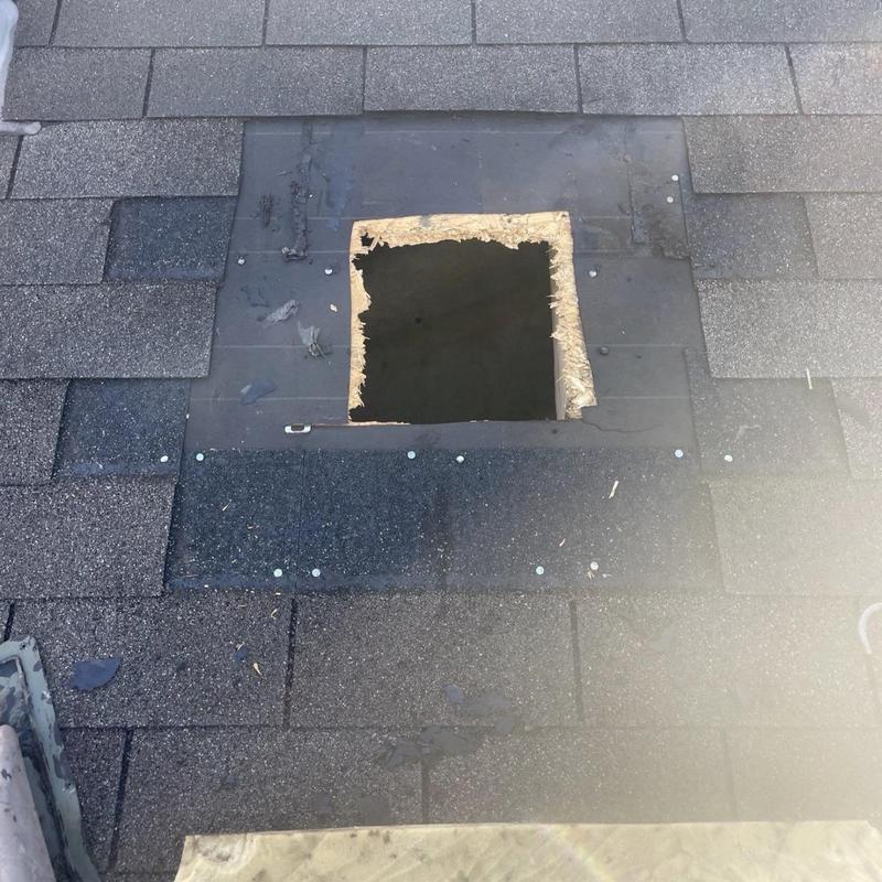 Roof vent opening with surrounding shingles and flashing