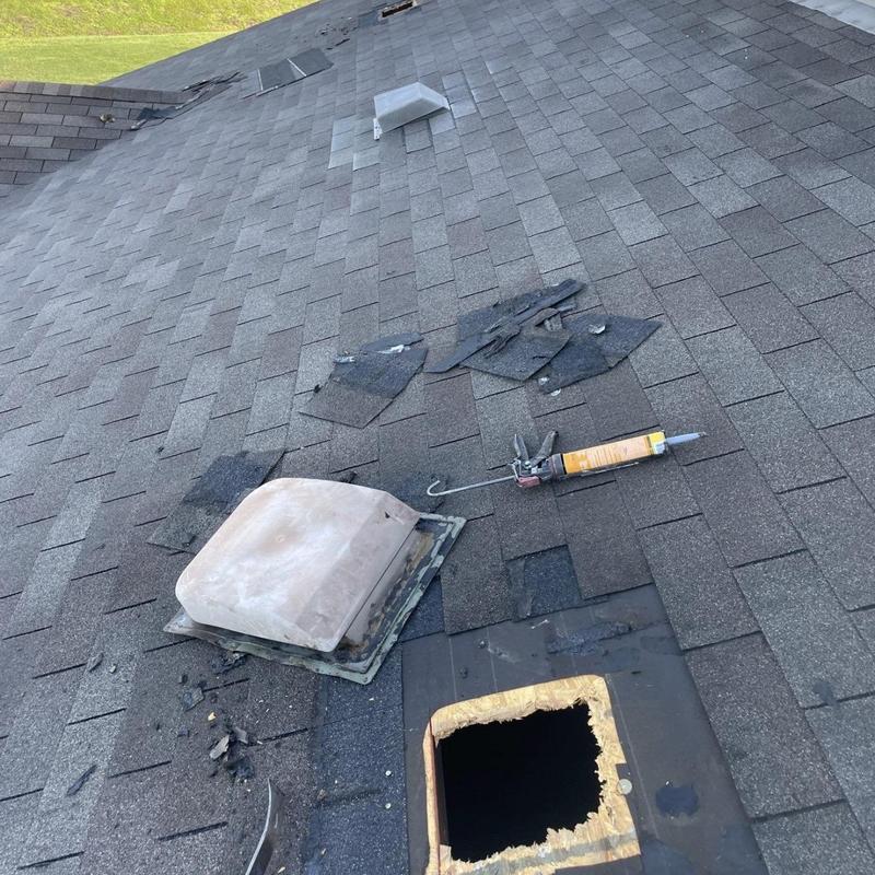 Roof vent removal and damaged shingle replacement on roof