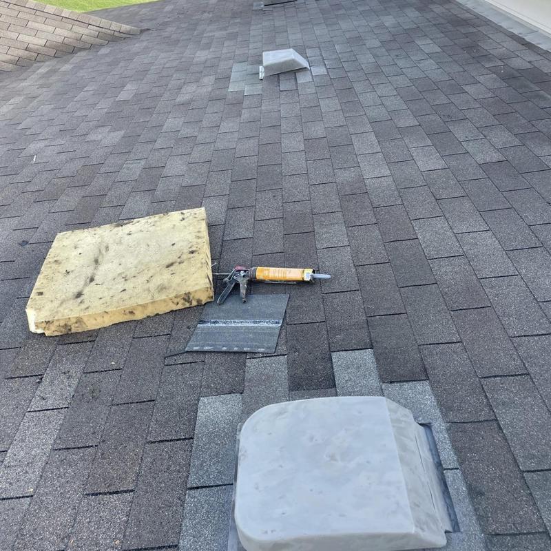 Roof vents with new shingles and flashing installed