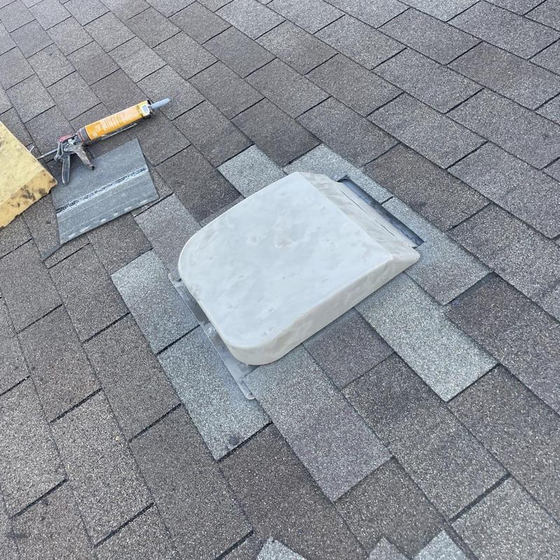 Roof vent with new shingles and flashing installation