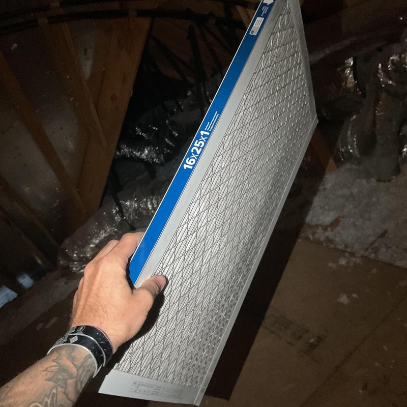 HVAC air filter being held for replacement in attic HVAC air filter being held for replacement in attic
