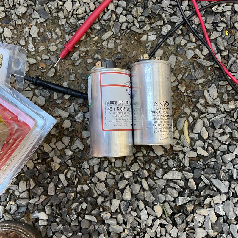 Dual run capacitors on gravel with test leads Dual run capacitors on gravel with test leads