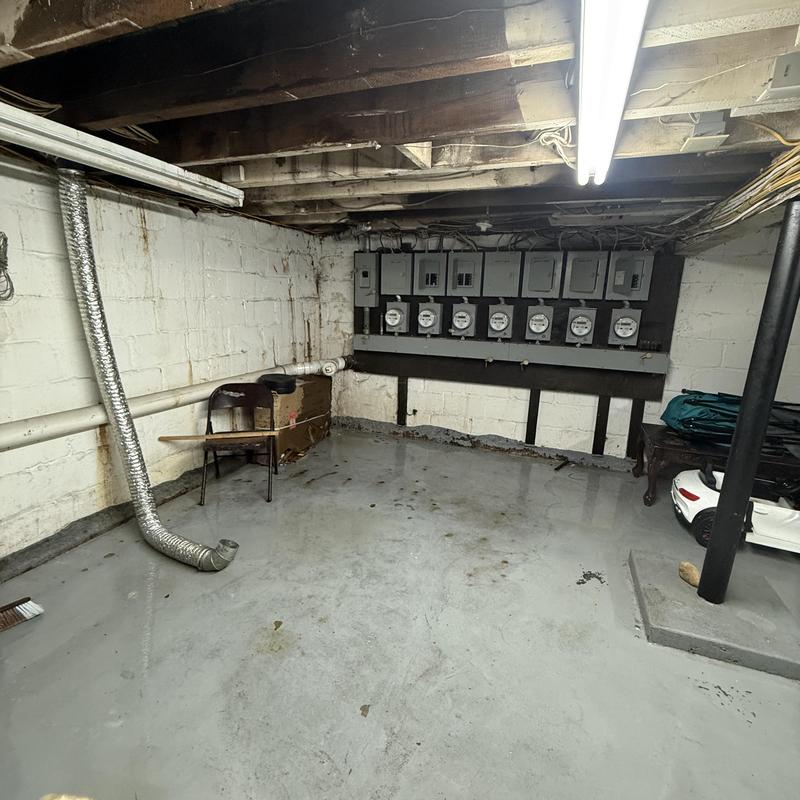 Basement drain pipe with vent duct in utility room Basement drain pipe with vent duct in utility room