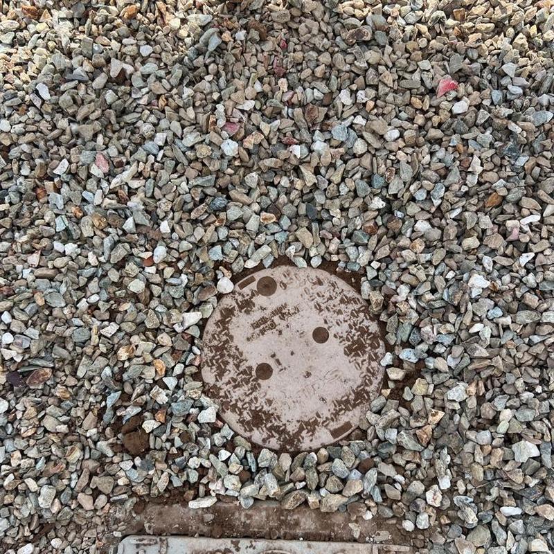 Pressure regulator valve cover box surrounded by gravel