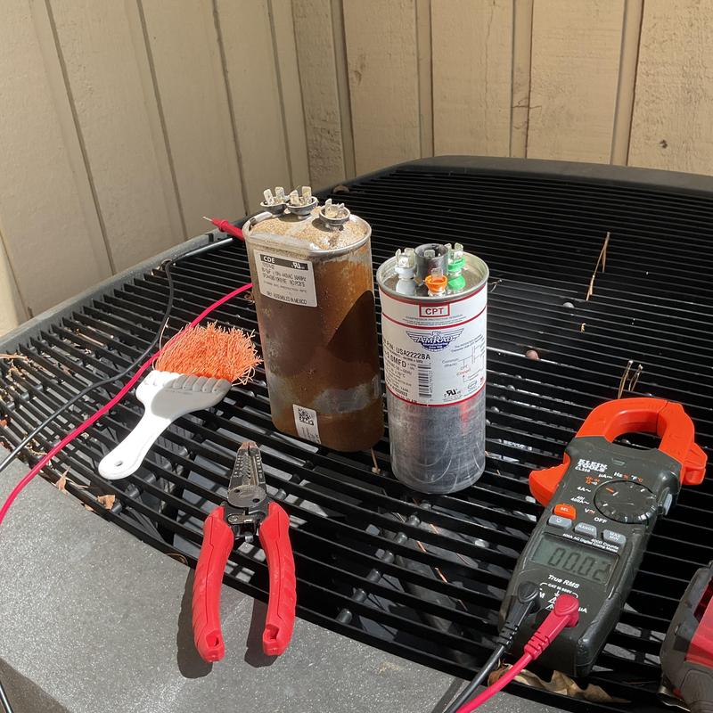 Compressor capacitors and electrical testing tools on AC unit Compressor capacitors and electrical testing tools on AC unit