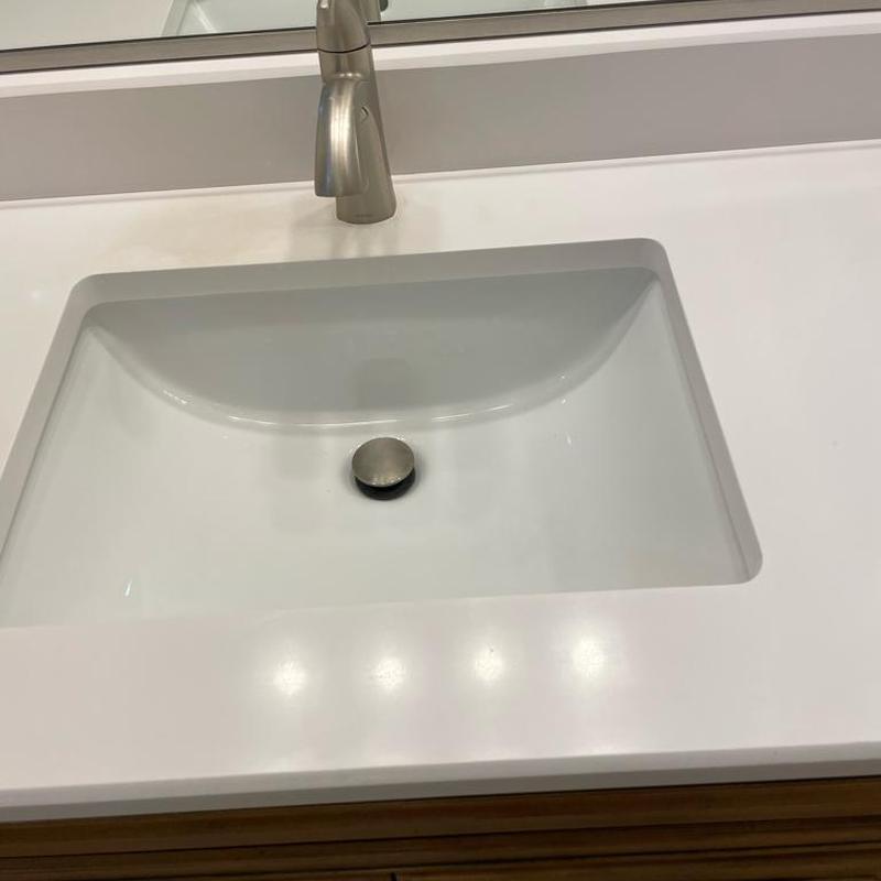 Under-mount bathroom sink with faucet and clean countertop