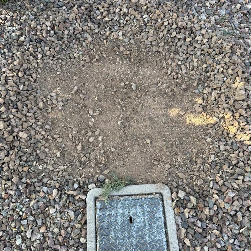 Pressure reducing valve access box with disturbed gravel