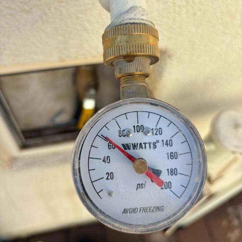 Pressure relief valve gauge showing 62 psi with tan access box