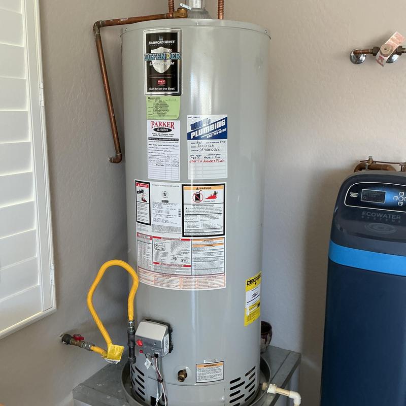 Water heater with anode rod installation and plumbing connections