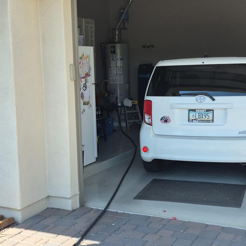 Water heater anode rod installation in residential garage
