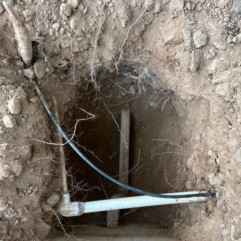 Main water line excavation and valve installation in soil