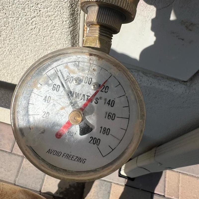 Pressure gauge on water line showing PSI reading
