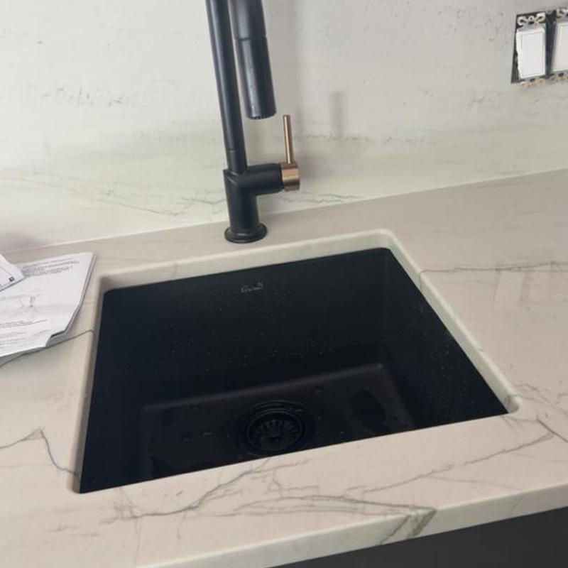 Black undermount kitchen sink with matte black faucet