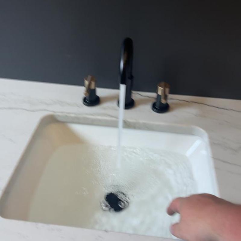 Bathroom sink faucet with running water and hand