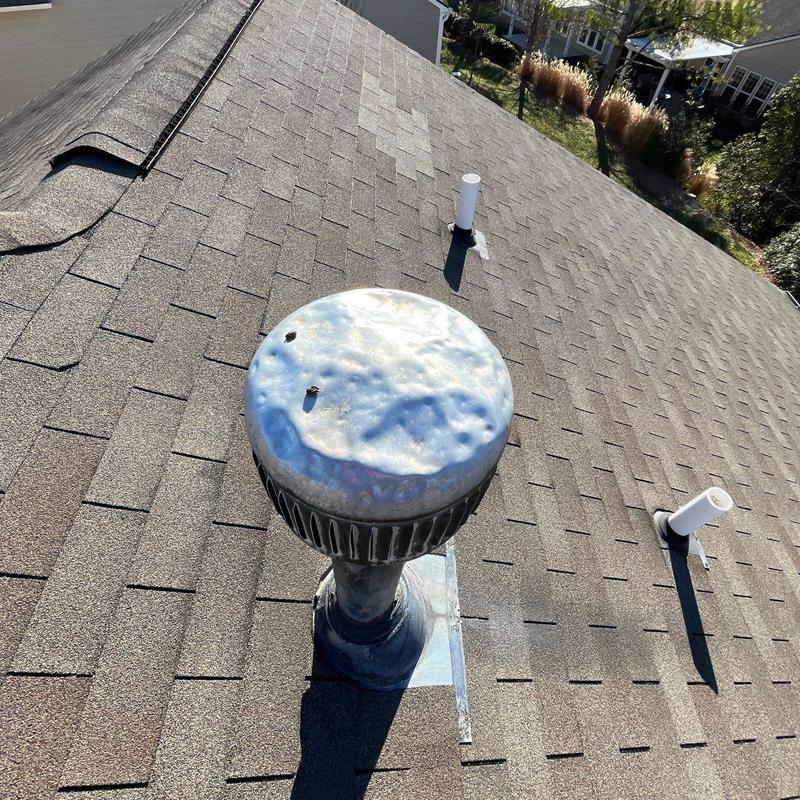 Roof shingles and metal vent with hail damage