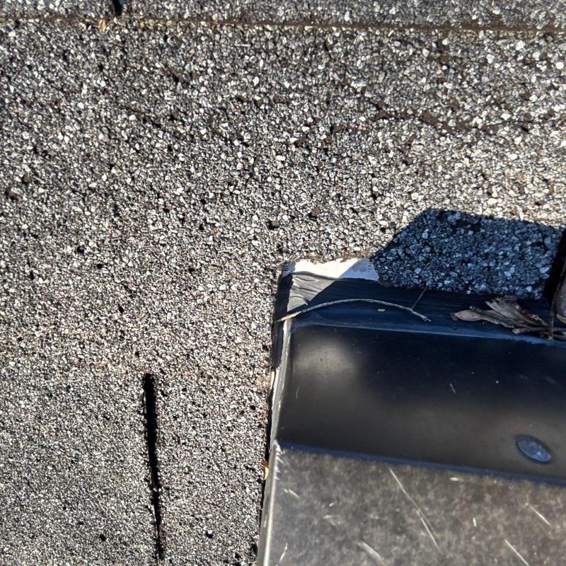 Roofing shingle edge with damage near metal flashing