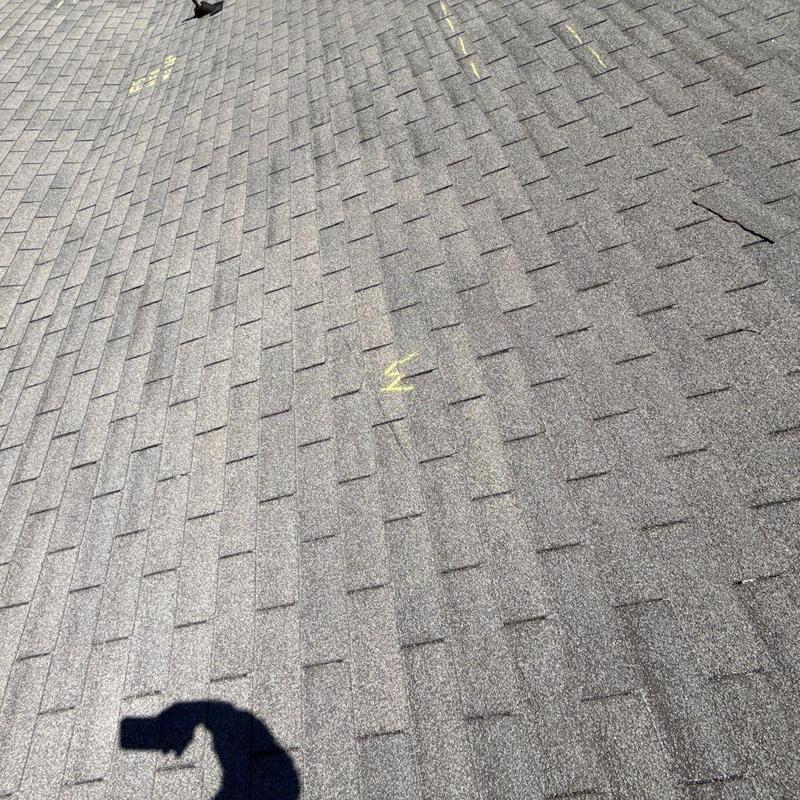 Asphalt shingle roof with hail damage marks