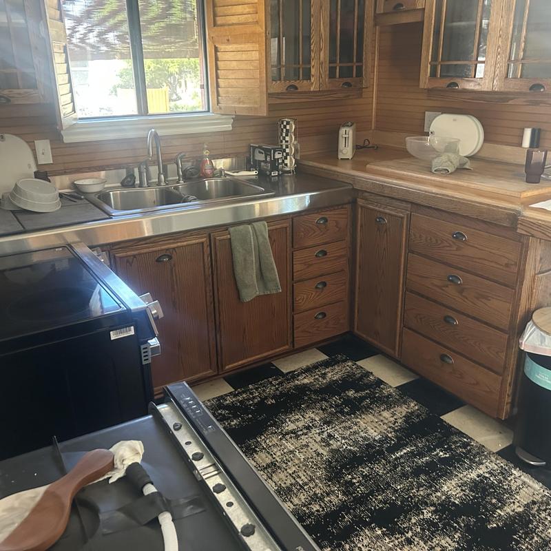 Kitchen faucet and double sink in wood cabinet kitchen