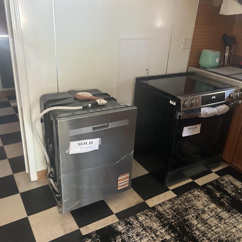 Dishwasher and stove awaiting kitchen remodel installation