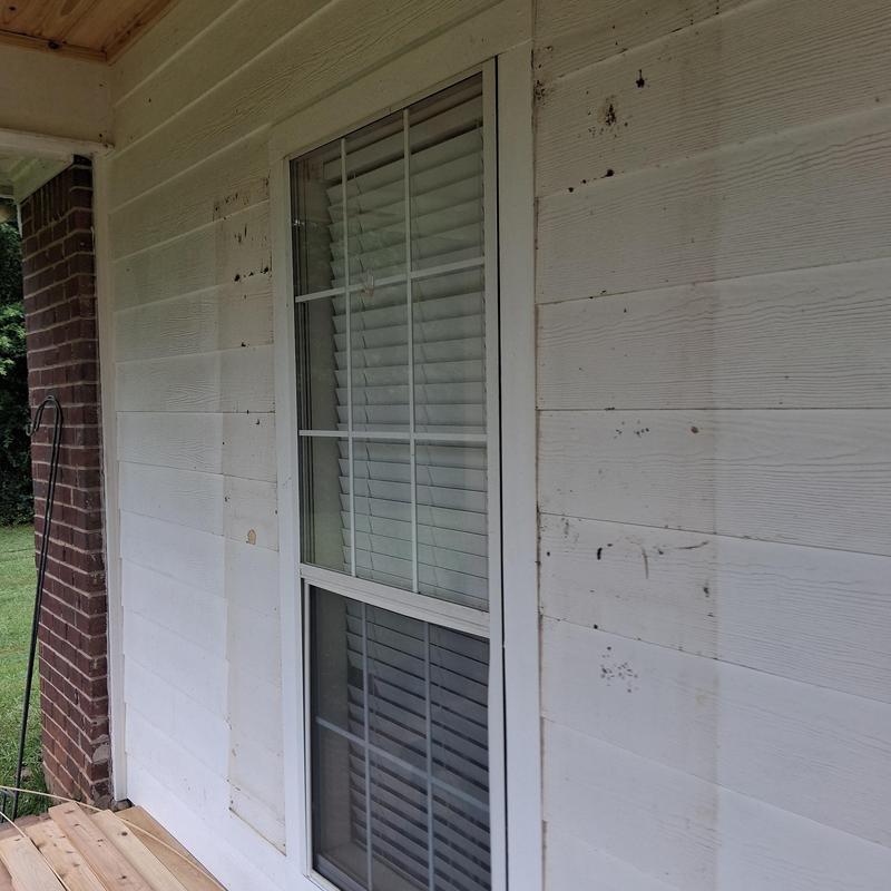 Custom window shutters installation on porch wall Custom window shutters installation on porch wall