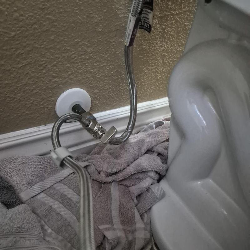 Quarter turn angle stop valve near toilet base