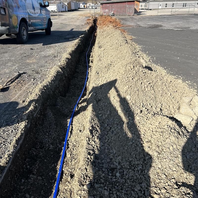 Water service line trench with new pipe installation