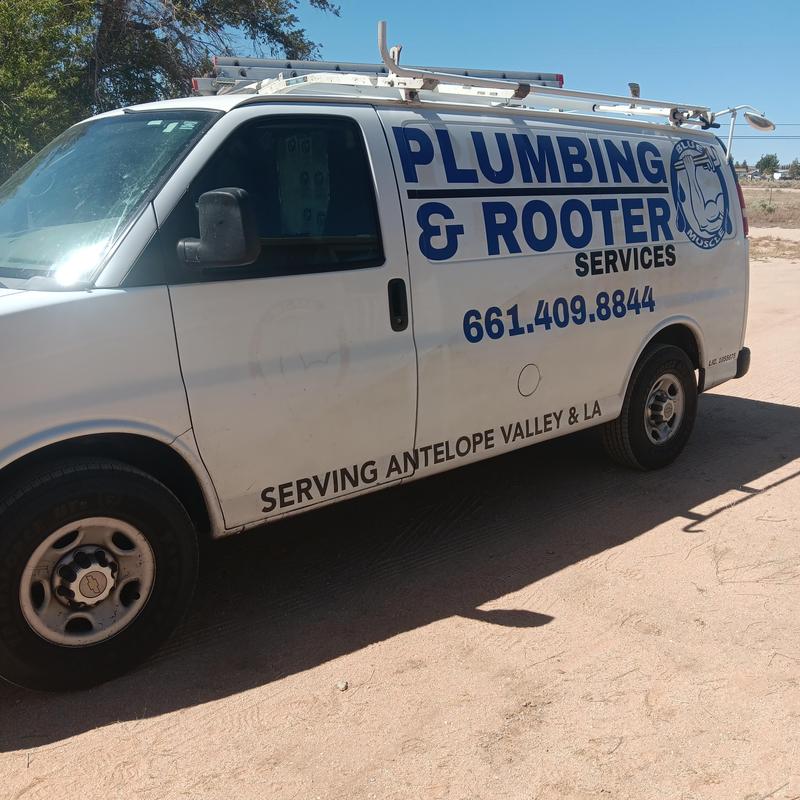 Plumbing and rooter service van with ladder equipment