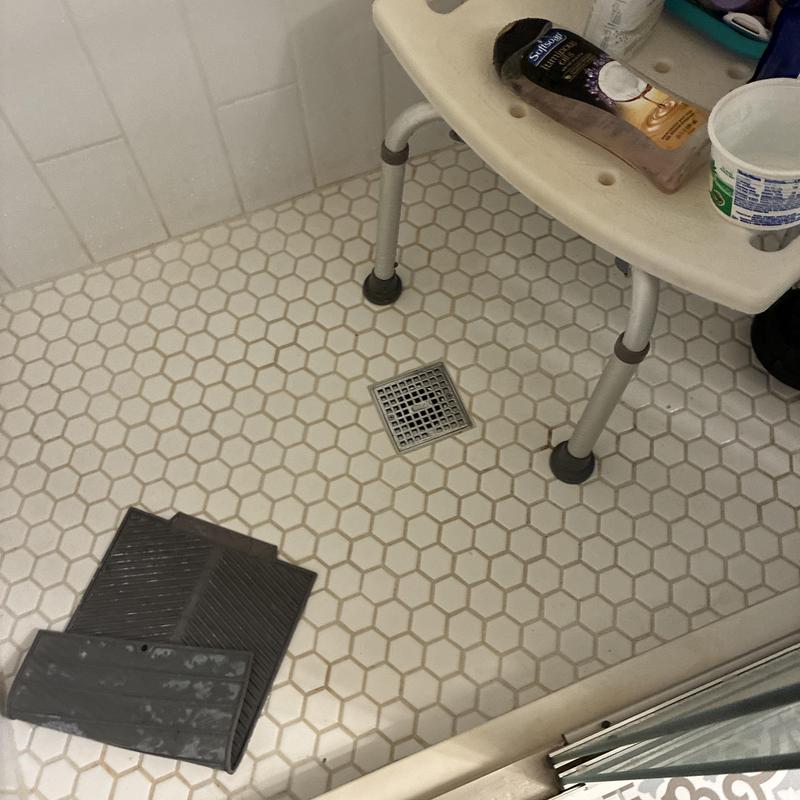 Shower drain and floor with shower chair and products