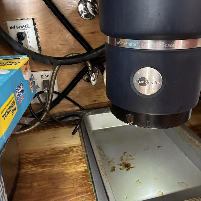 Garbage disposal unit with leak stains under sink