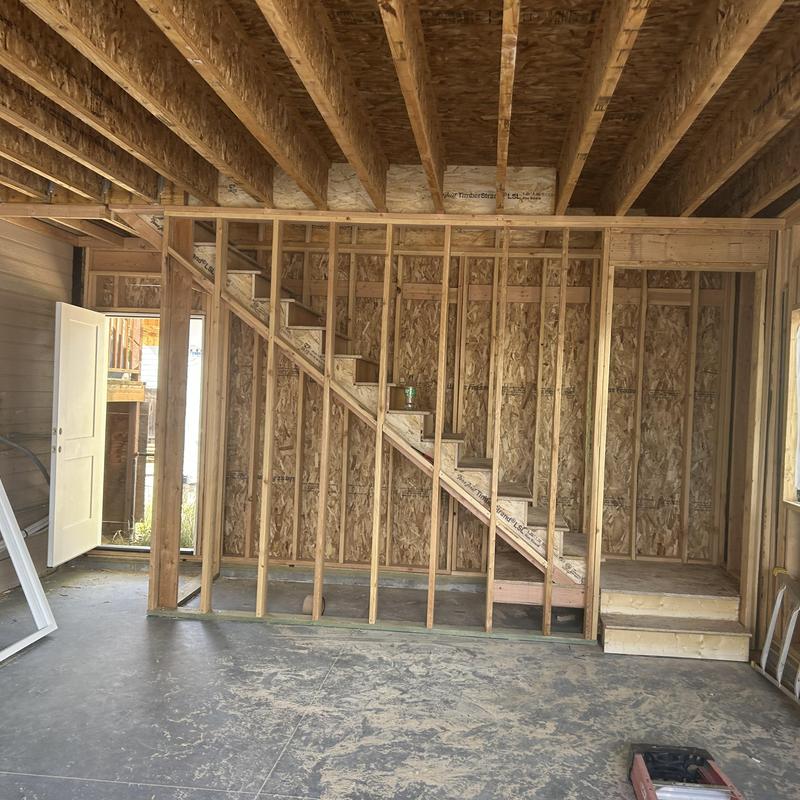 Wooden stair frame in unfinished room construction Wooden stair frame in unfinished room construction