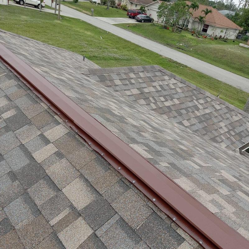 Asphalt shingle roof with new ridge cap installation Asphalt shingle roof with new ridge cap installation