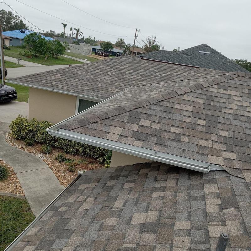 Architectural shingle roof with new gutters in Cape Coral Architectural shingle roof with new gutters in Cape Coral