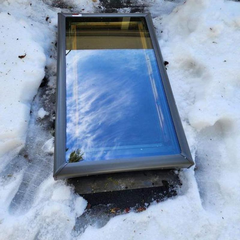 Deck mounted Velux skylight on snowy ground