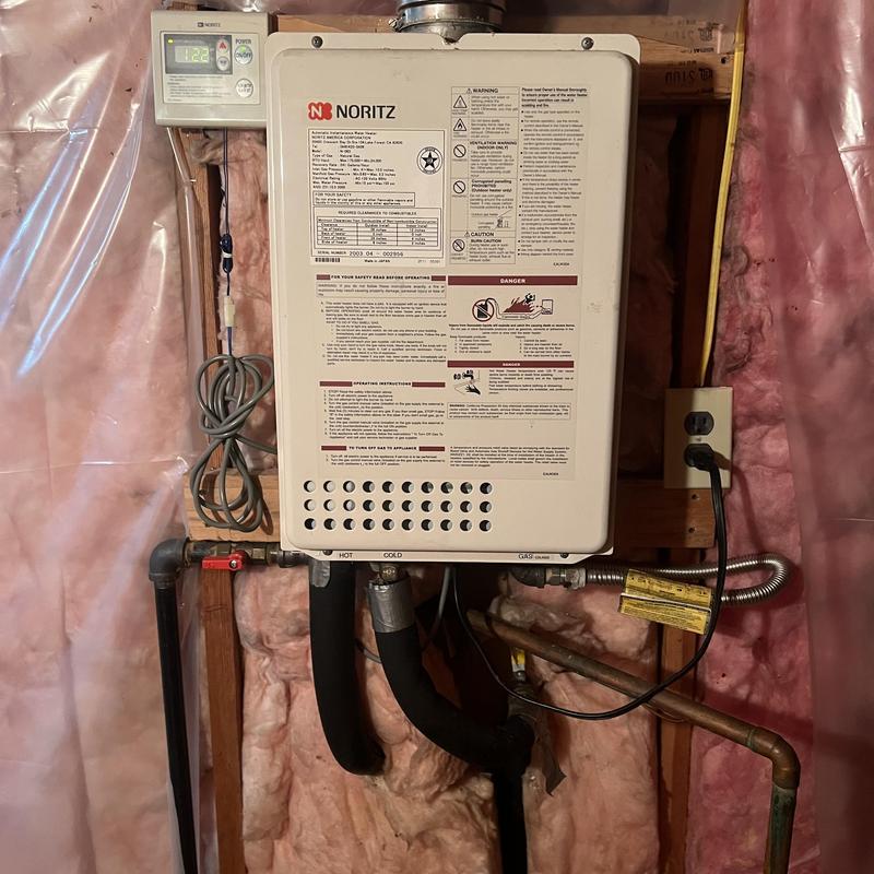 Tankless water heater in insulated basement wall