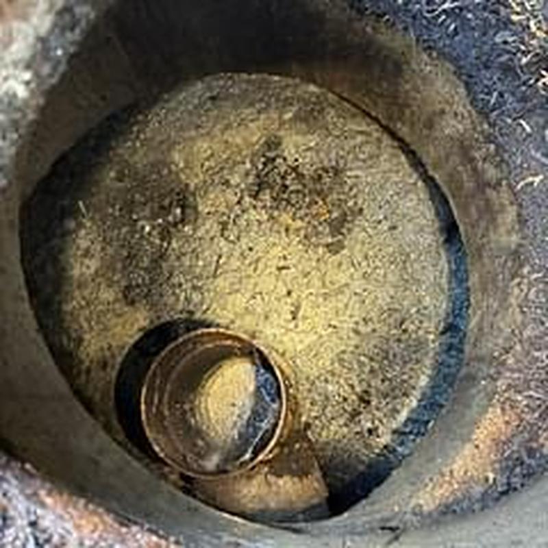 Floor sink drain with clog buildup inside pipe