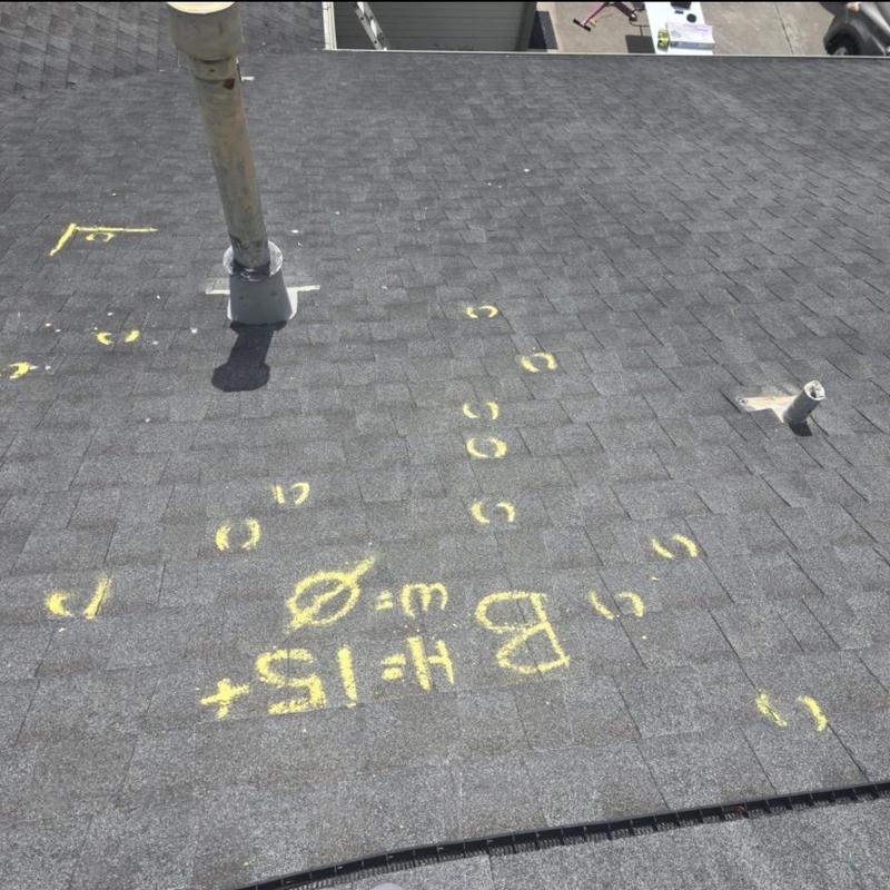Roof shingles with hail damage marks and annotations