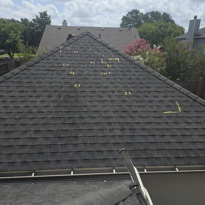 Asphalt shingle roof with marked hail damage spots