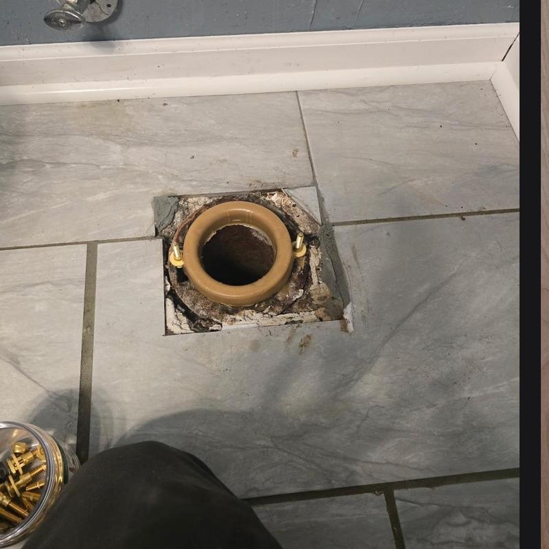 Toilet flange and sewer access in tiled floor