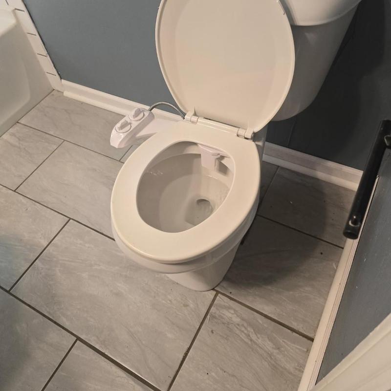Toilet with bidet attachment during plumbing service