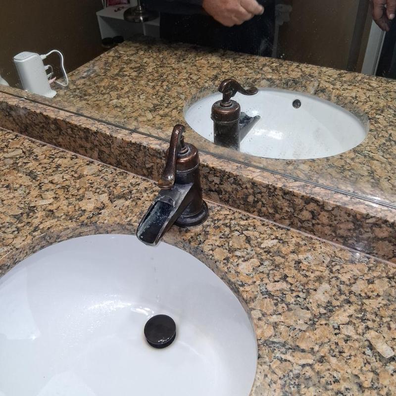 Single handle bathroom faucet on granite vanity top