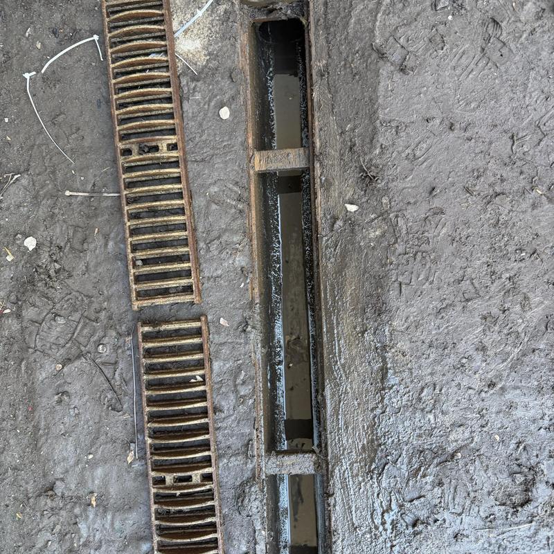 Loading dock drain with removed metal grate in mud Loading dock drain with removed metal grate in mud