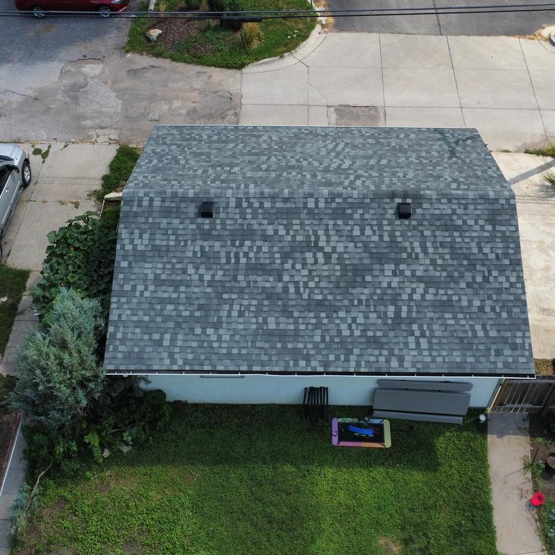 Asphalt shingle roof installation on residential building