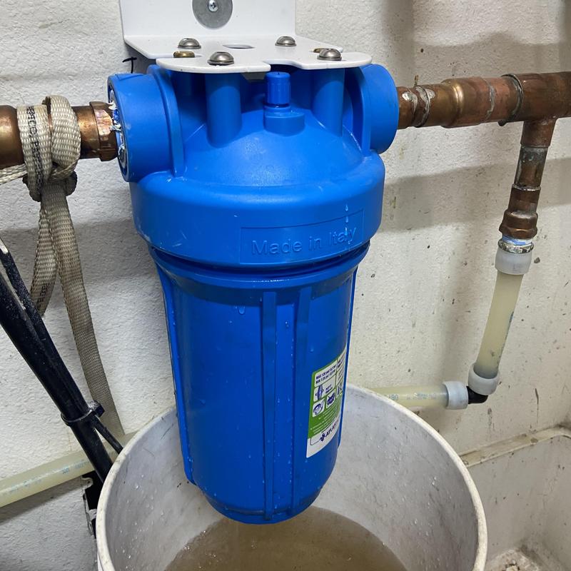Water filter cartridge housing installed on copper piping