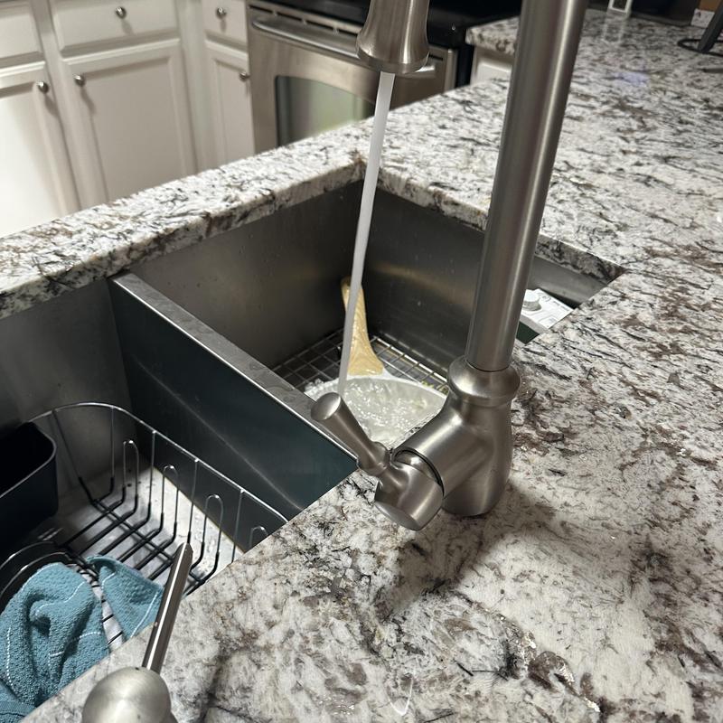 Kitchen faucet with running water and sink basin