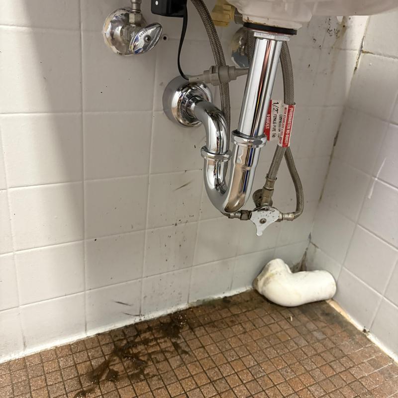 Chrome P-trap installation under sink at YMCA restroom Chrome P-trap installation under sink at YMCA restroom