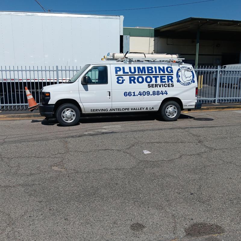 Plumbing and rooter services van parked street side