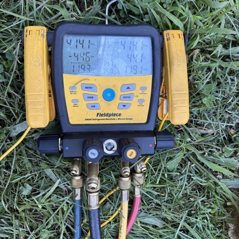 Refrigerant manifold gauge measuring HVAC system pressure Refrigerant manifold gauge measuring HVAC system pressure