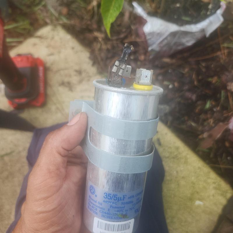 Capacitor with burnt wiring from HVAC compressor unit